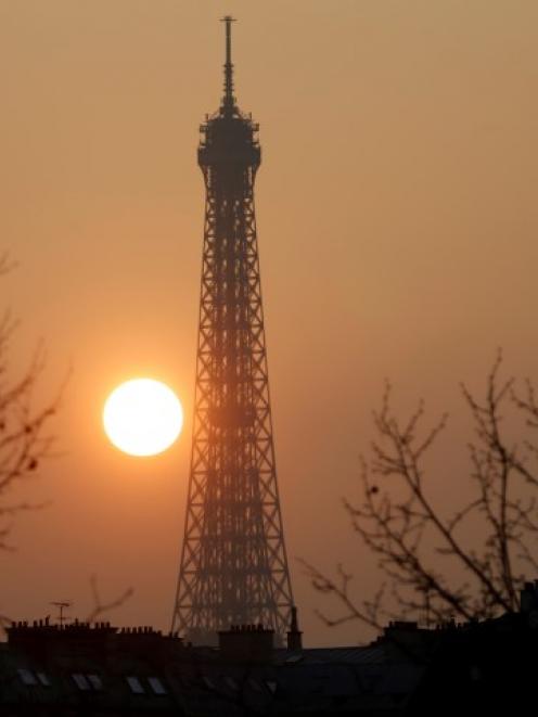 Sunset in Paris, which has been basking in a streak of unseasonable sunshine but also...