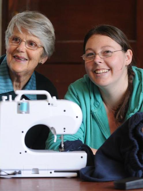 SuperGran Judy Breward (76, left) helps Michelle Whittaker (25) fix a pair of pants, in Dunedin....