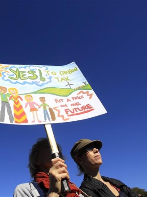 Supporters of a controversial carbon tax gather at a rally in Sydney. (AP Photo/Rick Rycroft)
