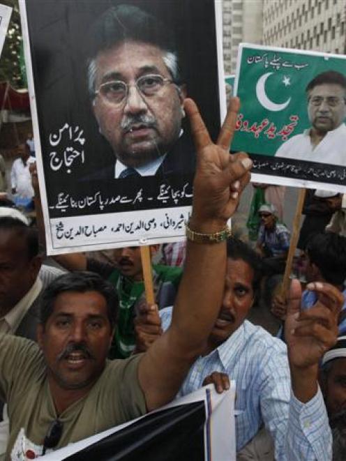 Supporters of former president Pervez Musharraf chant slogans on Sunday in Karachi, during a...