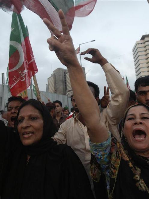Supporters of the Pakistan Tehreek-e-Insaf (PTI) political party of Pakistani cricketer-turned...