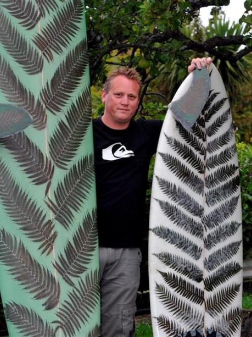 Surfing enthusiast Jeremy Buis with one of his fern leaf surfboards. Photo by Craig Baxter.