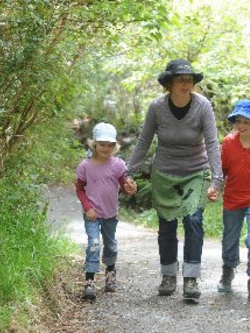 Swiss tourists Brigitte Schneider-Grimm and children Marlen (9) and Elsa Grimm (6) walk around...