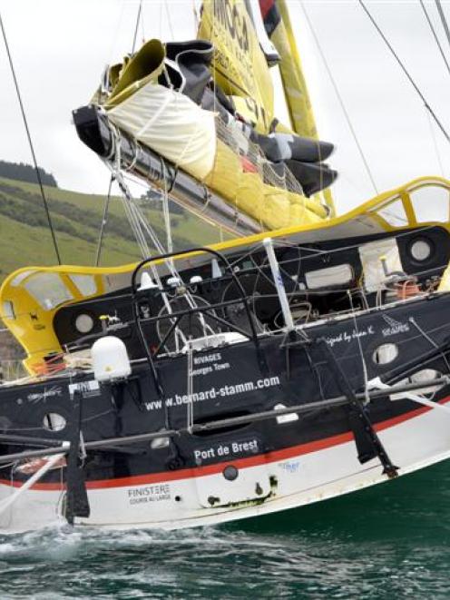 Swiss yachtsman Bernard Stamm stands on the stern of Cheminees Poujoulat  off Murdering Beach,...