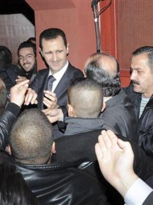 Syrian President Bashar al-Assad (centre) pledged his eternal refusal to negotiate with the '...