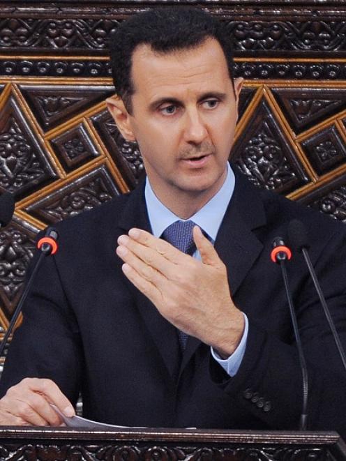 Syrian President Bashar Assad addresses the Parliament, in Damascus. (AP Photo/SANA, File)