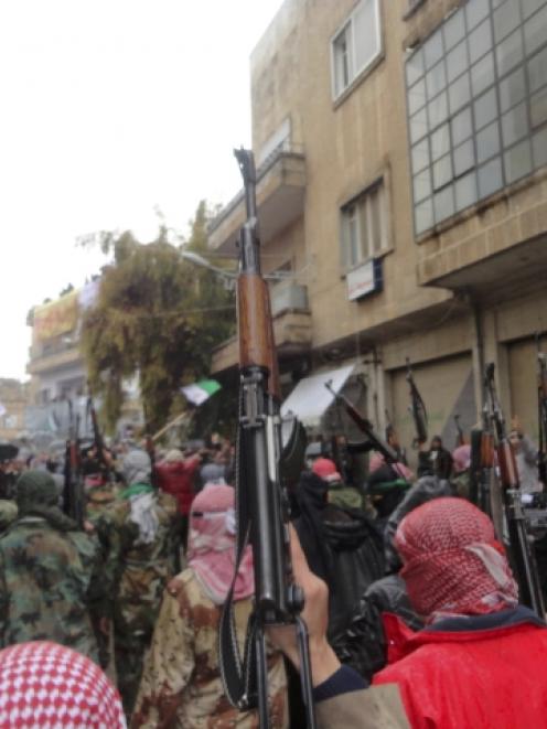 Syrian soldiers who defected to join the Free Syrian Army are seen among demonstrators during a...