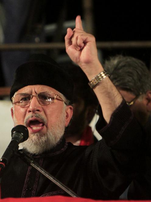 Tahir ul-Qadri, Sufi cleric and leader of political party Pakistan Awami Tehreek (PAT), addresses...