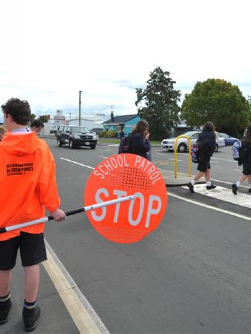 Taieri College school patrol member Zac Henry (12), from Mosgiel, waits while his fellow pupils ...