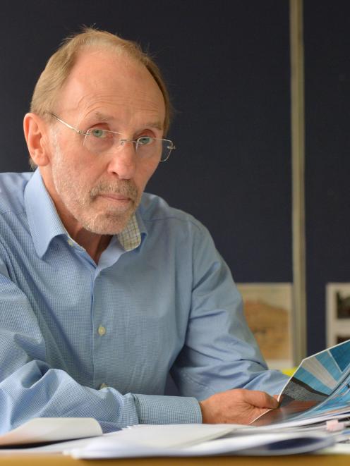 Taieri Community Facilities Trust chairman Michael Stedman  holds  draft plans for a $15 million...