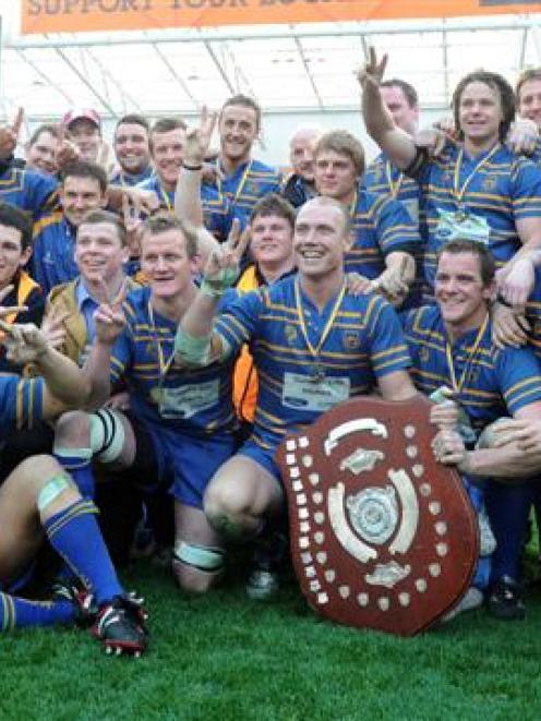 Taieri players and management celebrate their second successive title. Photos by Craig Baxter.