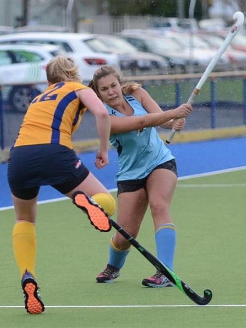 Taieri's Emily Sclater (left) evades the strike of  University A's Morgan Spittal during their...