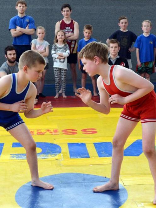 Taieri Wrestling Club members Cameron Lord (left) and Jalen Forgie (both 9) face off in the...