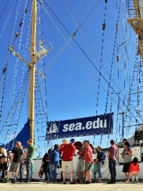 Members of the public queue to board the Robert C, Seamans tall ship research vessel berthed in...