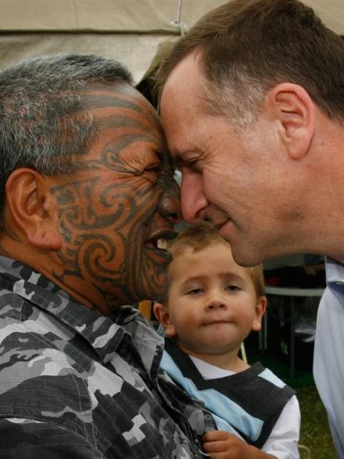 Tame Iti with his grandson Te Rangimoaho (20mths) meet National Party Leader John Key on the...