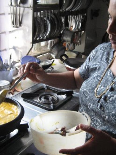 Chef Leena Sham prepares Malabar fish curry. Photo by Charmian Smith
