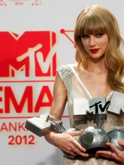 Taylor Swift poses with her Best Female, Best Live and Best Look awards backstage during the MTV...