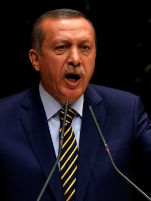 Tayyip Erdogan addresses members of his ruling AK Party during a meeting at party headquarters in...