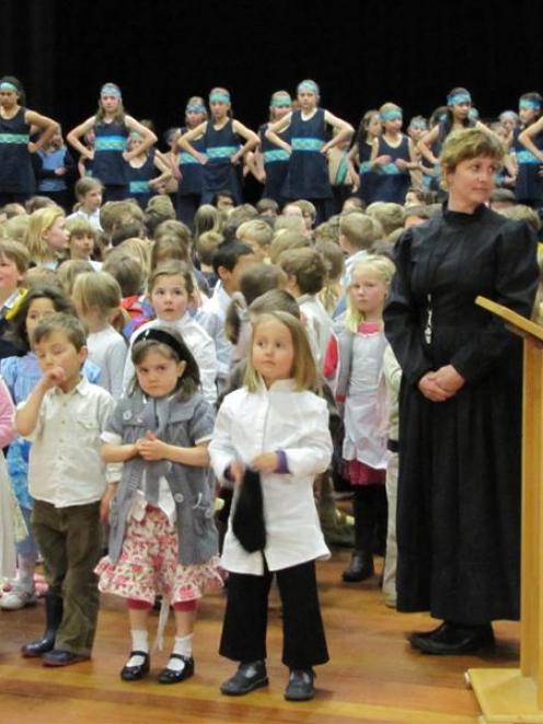 Teacher Leeanne Fairbairn (right) and some of her room 1 pupils (front row) perform at the...