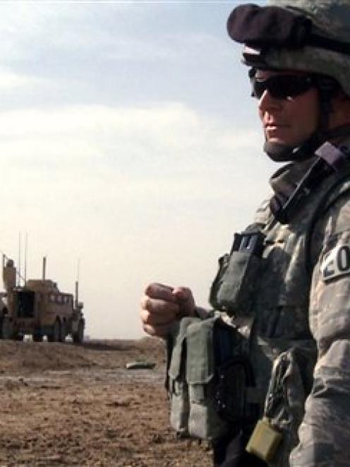 Tech Sergeant Jeremy Phillips waits for his team members to prepare a detonation outside Forward...