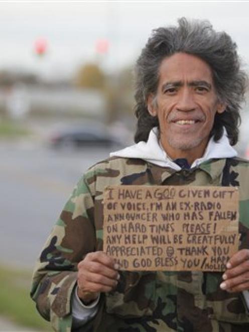 Ted Williams holds a sign advertising his smooth radio voice near a highway ramp in Columbus,...