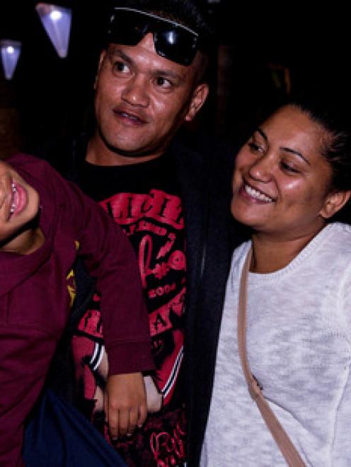 Teina Pora gets a hug from his daughter Channelle and his grandson Benson, age 5, following the...