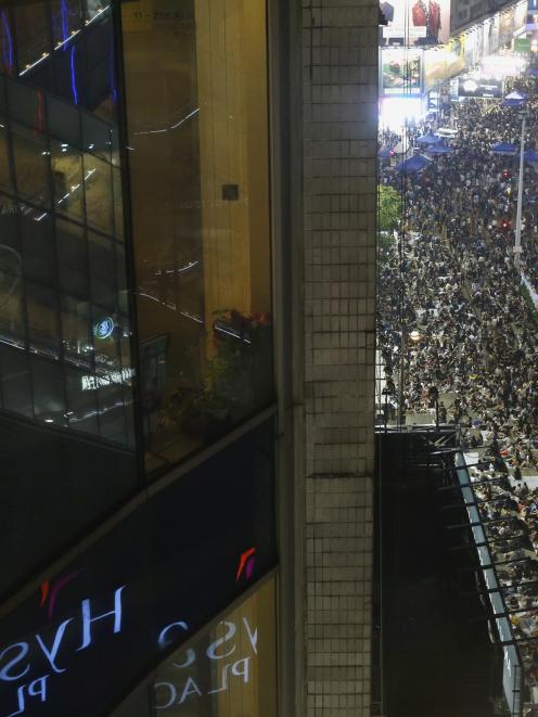 Tens of thousands of pro-democracy protesters extended a blockade of Hong Kong streets,...