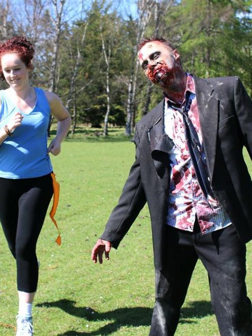 Tessa Sutcliffe (18) passes  zombie Rory Foley in a Zombie Run practice at Waimate's Knottingley...