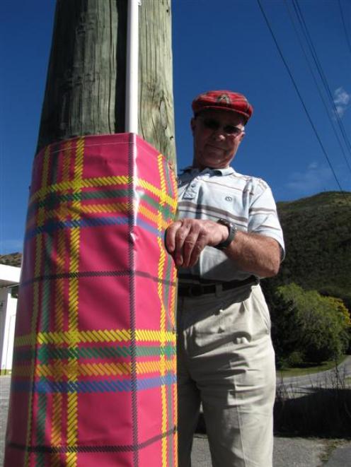Teviot Valley Scottish Week organising committee member Ken Bain checks the festive sleeves on...