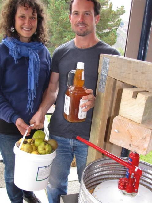 The apple press made from recycled objects by Robbie Lawton, pictured with Christine Rozon (both...