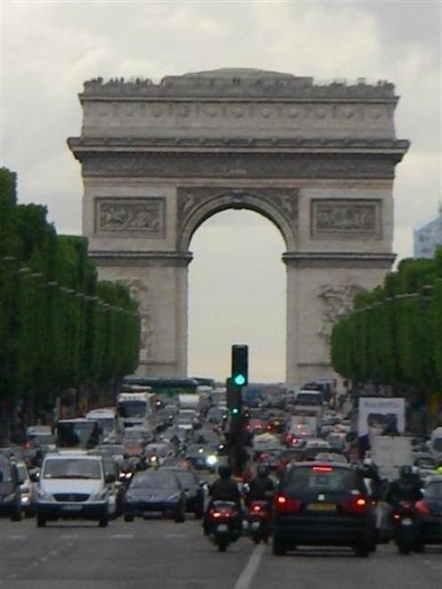 The Arc de Triomphe looms above one of the world's most famous thoroughfares, the Champs-Elysees....