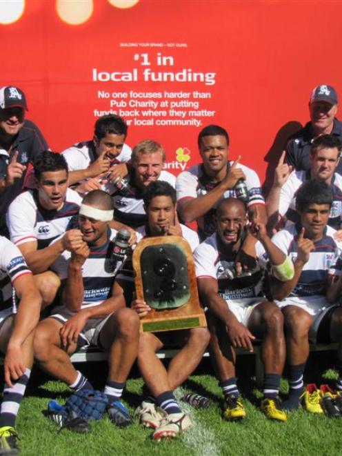 The Auckland squad celebrates with the trophy after winning the National sevens tournament in...