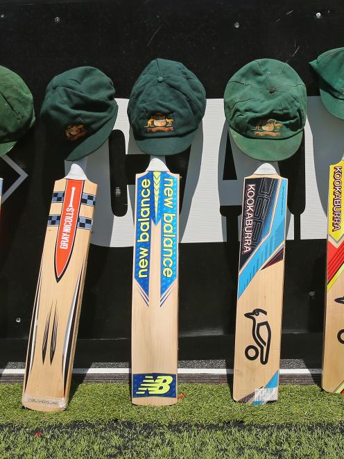 The bats and caps of the Australian cricket team are left by the field in a tribute to the late...