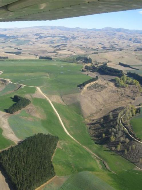 The benefits of irrigation can be seen in the contrast between watered green pastures and...