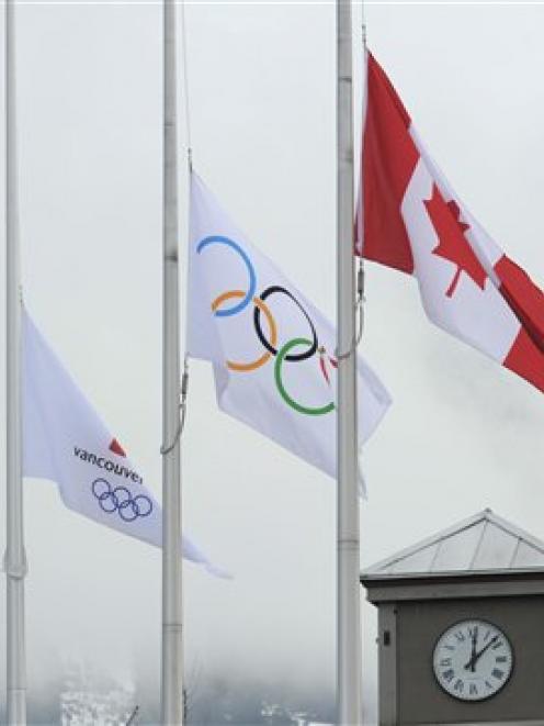 The Canadian, Olympic and Vancouver 2010 flags fly at half-mast in respect of luge athlete Nodar...