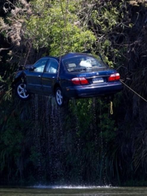 The car involved in the incident on Sunday was lifted from the Waikato River yesterday. Photo /...
