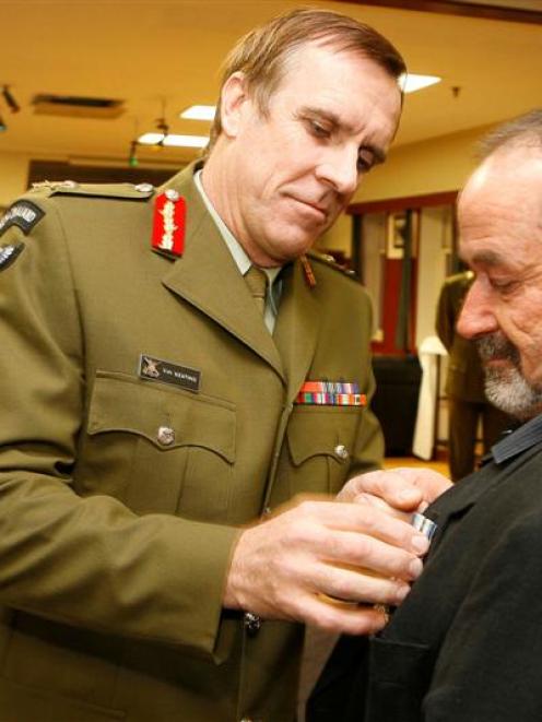 The Chief of the New Zealand Army, Major-general Tim Keating, presents the NZ Special Service...