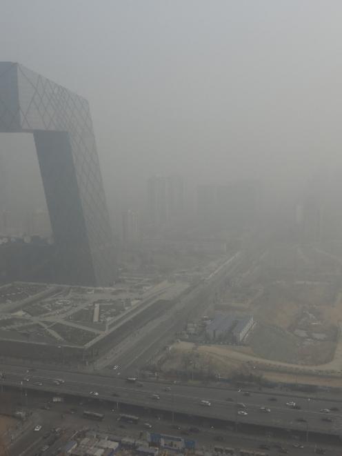 The China Central Television (CCTV) building is seen next to a construction site in heavy haze in...