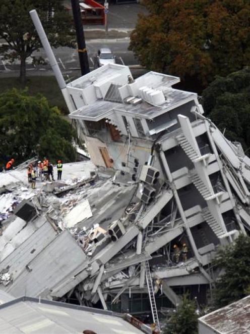 The collapsed Pyne Gould Corporation building in Christchurch. Photo by <i>The New Zealand Herald...