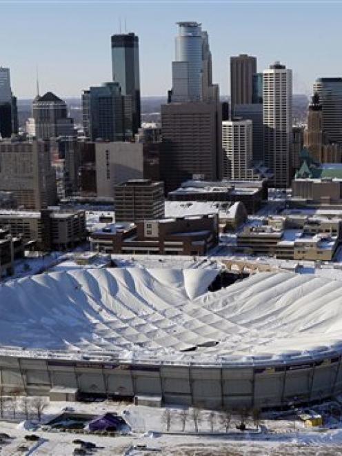 The collapsed roof of the Metrodome is shown in this aerial view of Minneapolis. (AP Photo/Ann...