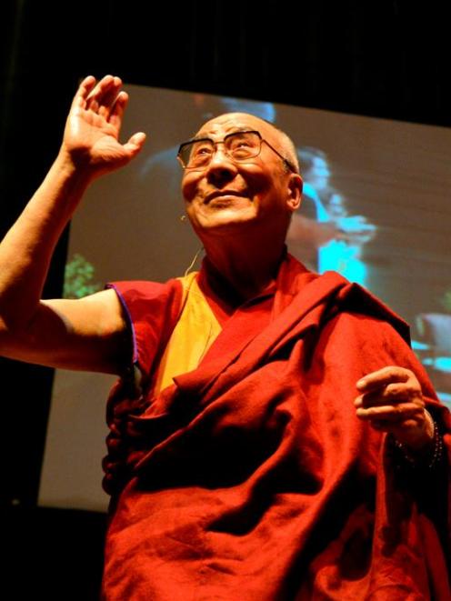 The Dalai Lama acknowledges a standing ovation at the start of his Dunedin Town Hall talk. Photo...