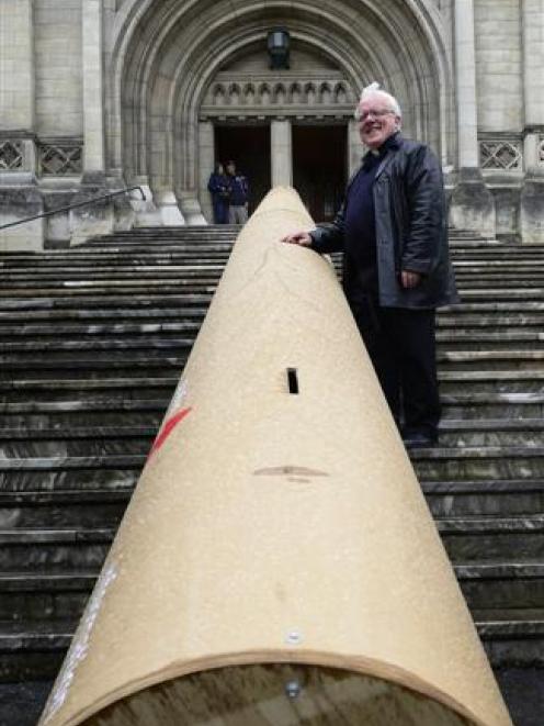 The  Dean of St Paul's,  the Very Rev Dr Trevor James, with a 16m cardboard tube outside St Paul...