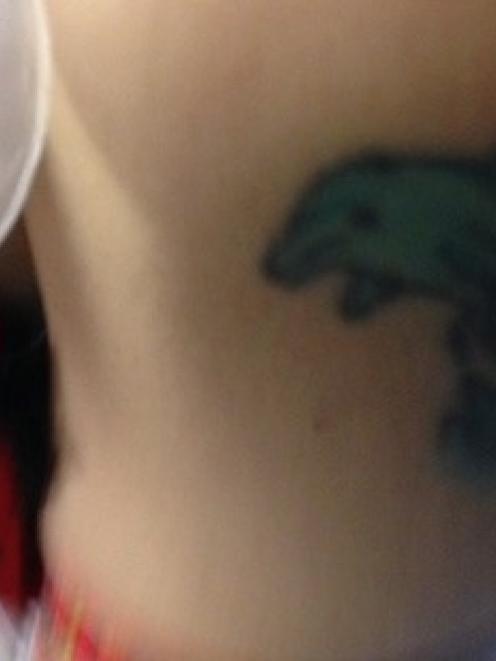 The dolphin tattoo police hope will help them identify the woman. Photo NZ Police