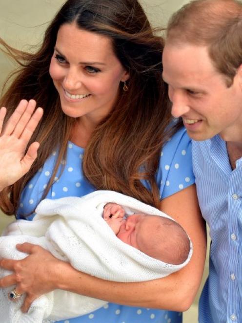 The Duke and Duchess of Cambridge with their son, Prince George. REUTERS/John Stillwell