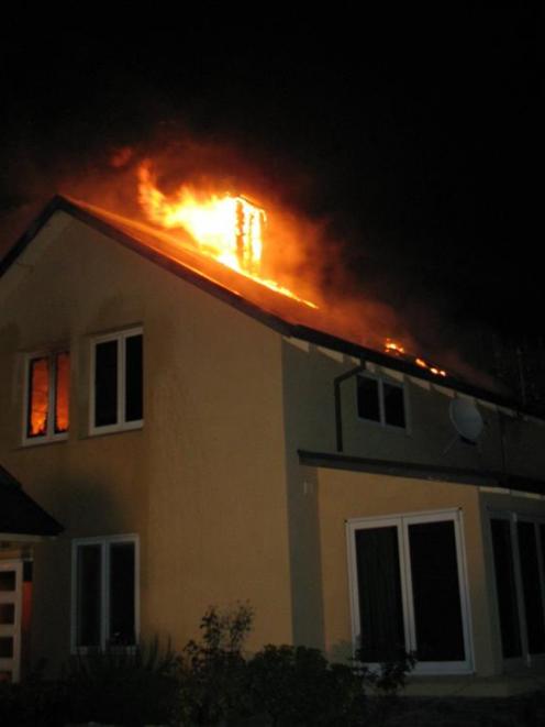 The fire takes hold of the house in Glencoe Rd, Crown Terrace, on Monday night. Photo by Dave...