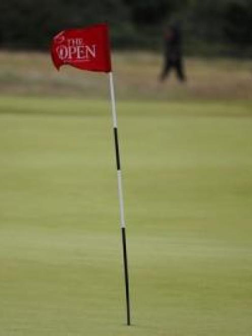 The flag at the 15th hole waves in the strong winds which saw play suspended on the third day at...