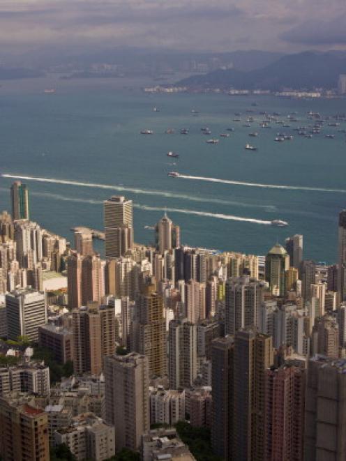 The fog burns off to provide a dramatic view of Hong Kong from the top of Victoria Peak. (Photo...