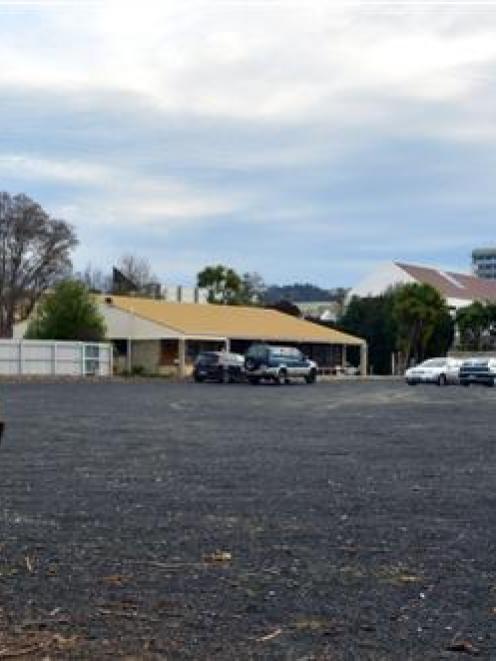 The gravel car park, viewed from the edge of Logan Park looking towards Otago Polytechnic, that...