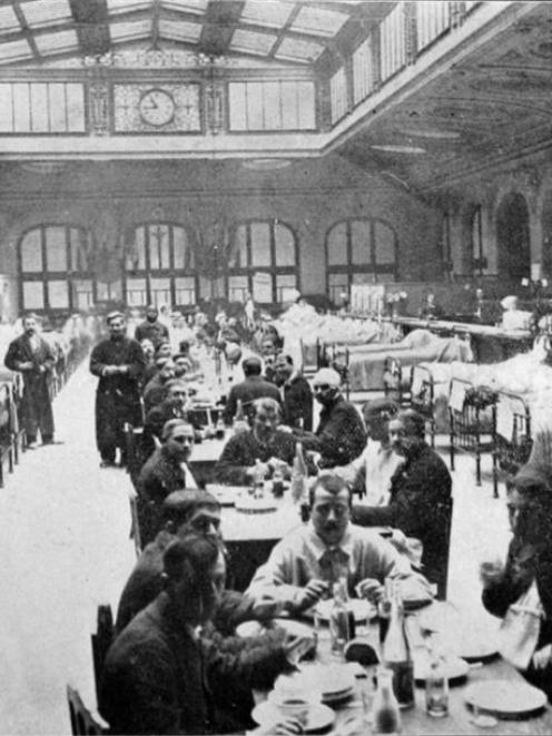 The great hall of the P. M. L. company's railway station in Paris is now a huge hospital for...