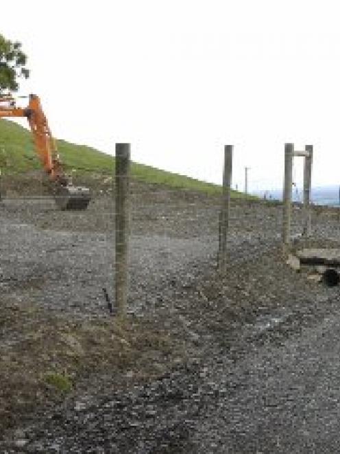 The just-installed fenceline and access point to the Saddle Hill quarry which has local residents...